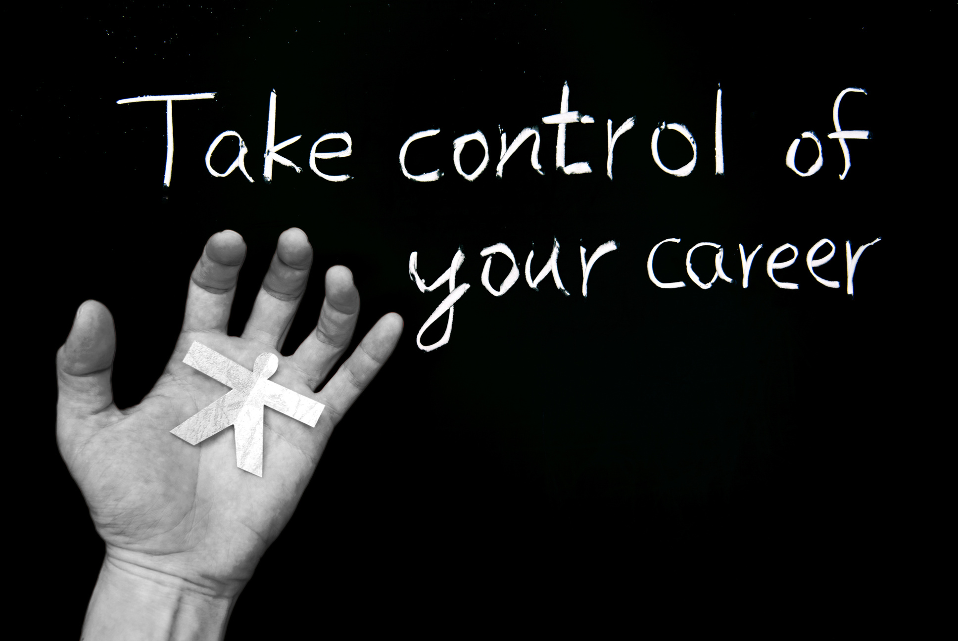 A hand holding a paper cutout of a person is shown on the left side of the image, symbolizing empowerment. The background is black, and to the right, white text reads "Take control of your career," suggesting it's time to update your resume.