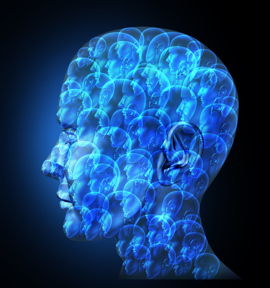 A blue digital rendering of a human head composed of multiple smaller, semi-transparent human heads. The image creates an intricate, overlapping pattern, illustrating the complexity of the human mind, akin to the interconnectedness seen on social media. The dark background highlights the luminous blue heads.