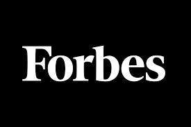 The image showcases the Forbes magazine logo, featuring the word "Forbes" boldly written in a white, serif font centered against a sleek black background.