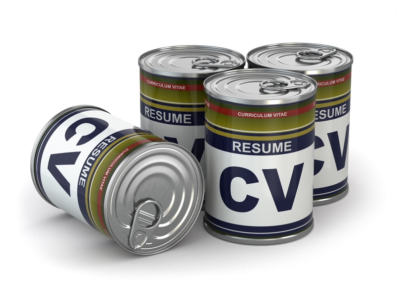 Four tin cans with labels reading "RESUME" and "CV" are arranged in a cluster, designed to resemble canned food with colorful labels and metallic tops. The image suggests the idea of pre-packaged resumes, perfectly highlighting the convenience of having your credentials ready at any time.