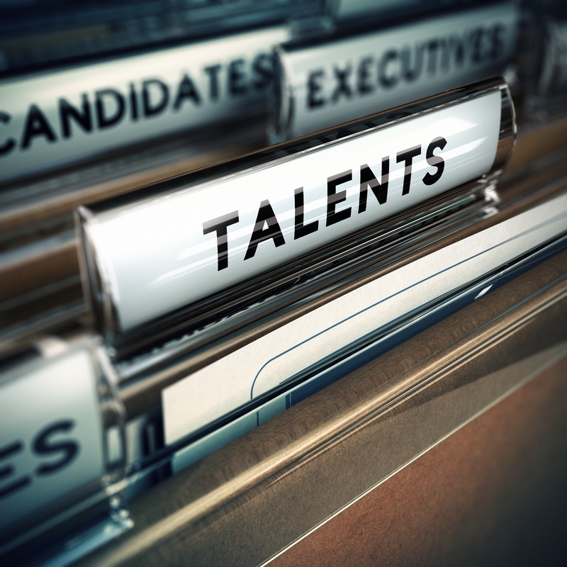 Close-up of a file organizer with a labeled tab reading "TALENTS." The file is part of a drawer filled with other labeled files, such as "CANDIDATES" and "EXECUTIVES." The focus is on the "TALENTS" tab, suggesting the organization or sorting of resume-related documents.