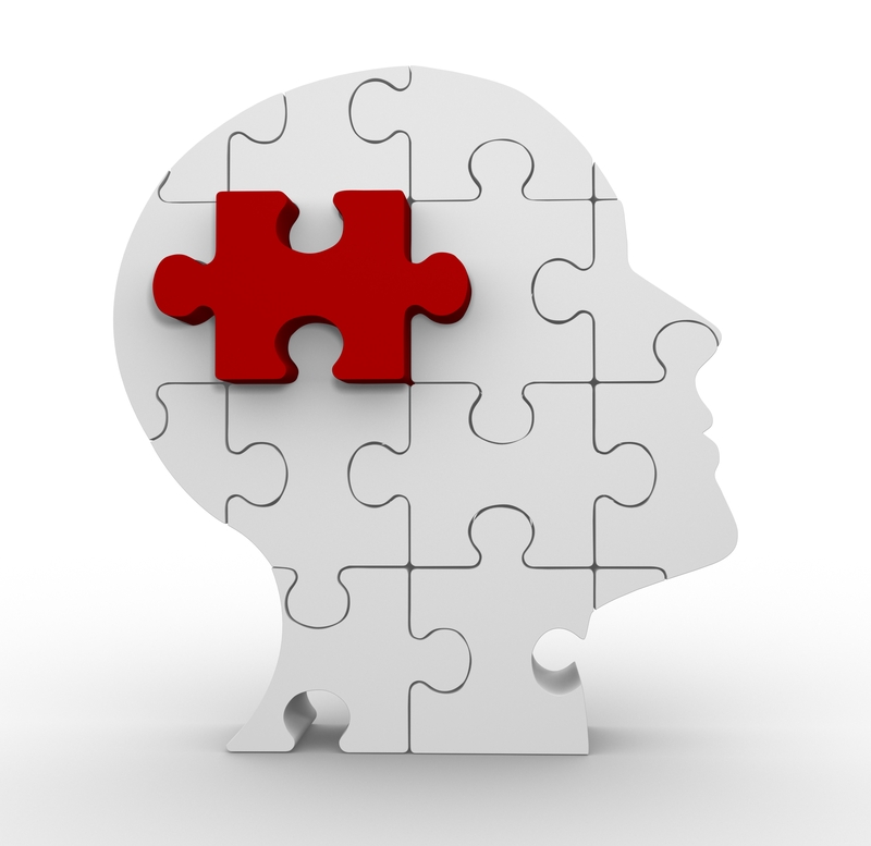 A white puzzle in the shape of a human head with a red puzzle piece missing from the top left section reflects the concept of outsourcing. The rest of the pieces are intact, forming a complete silhouette of a head in profile, highlighting how outsourcing fills critical gaps.