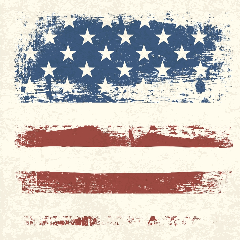 Rough, grungy illustration of the United States flag, honoring veterans. The flag features the blue field with white stars in the upper left corner and red and white stripes below. The colors and patterns have a distressed, weathered appearance.