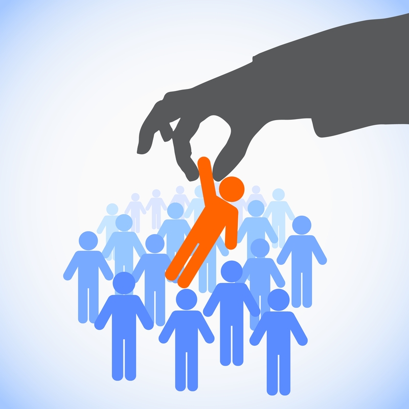 Illustration of a large hand picking up an orange figure from a group of blue figures against a light blue background. The image suggests selection or recruitment, highlighting the role of a mentor in guiding individuals.