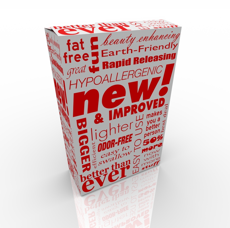A product packaging featuring various promotional words in red on a white box. Text includes phrases like "new! & improved," "Earth-Friendly," "fat free," "lighter," "odor-free," "hypoallergenic," and "BIGGER GOVERNMENT" among others, in different fonts and orientations.
