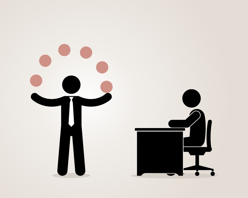 Illustration of a person in a suit juggling six balls standing next to a seated individual at a desk. The seated person, possibly in an interview, is facing the desk while the juggler displays a skillful act, symbolizing multitasking or managing multiple responsibilities.