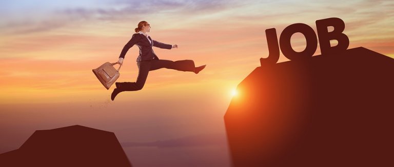A person in business attire is leaping across a gap between two cliffs, carrying a briefcase. The cliff they are jumping towards has the word "JOB" on it. With the promise of a raise and a warm sunset in the background, the scene captures ambition and determination.