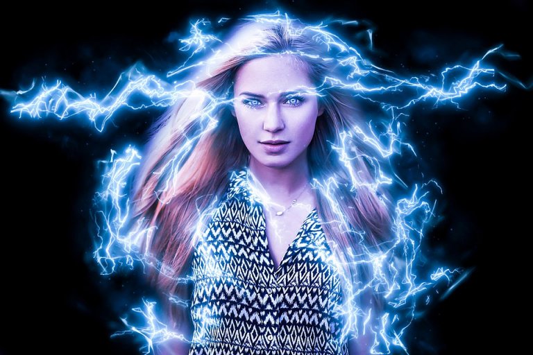 A woman with long, flowing hair stands confidently, surrounded by bright blue electric energy arcs emanating from her superpowers. She is wearing a patterned dress, and the dark background makes the electric energy appear vibrant and dynamic. The image has a powerful and mystical vibe.
