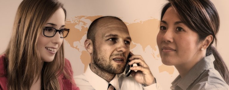 Three people depicted in a single image: a woman with glasses smiling, your boss in the center talking on a phone, and a woman on the right looking towards the camera. A light brown world map is faintly visible in the background.