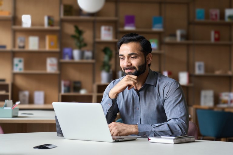 A man thinking in front of a laptop