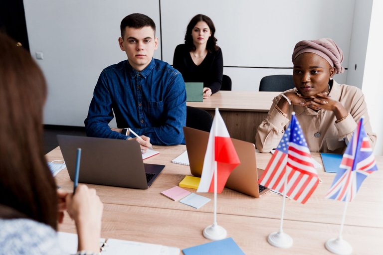 A team with different ethnicities in office room discussing