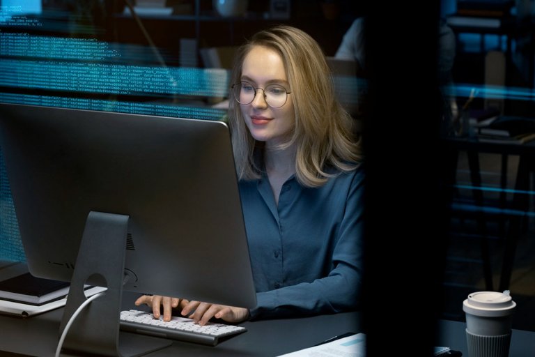 A software engineer using her personal computer to do coding